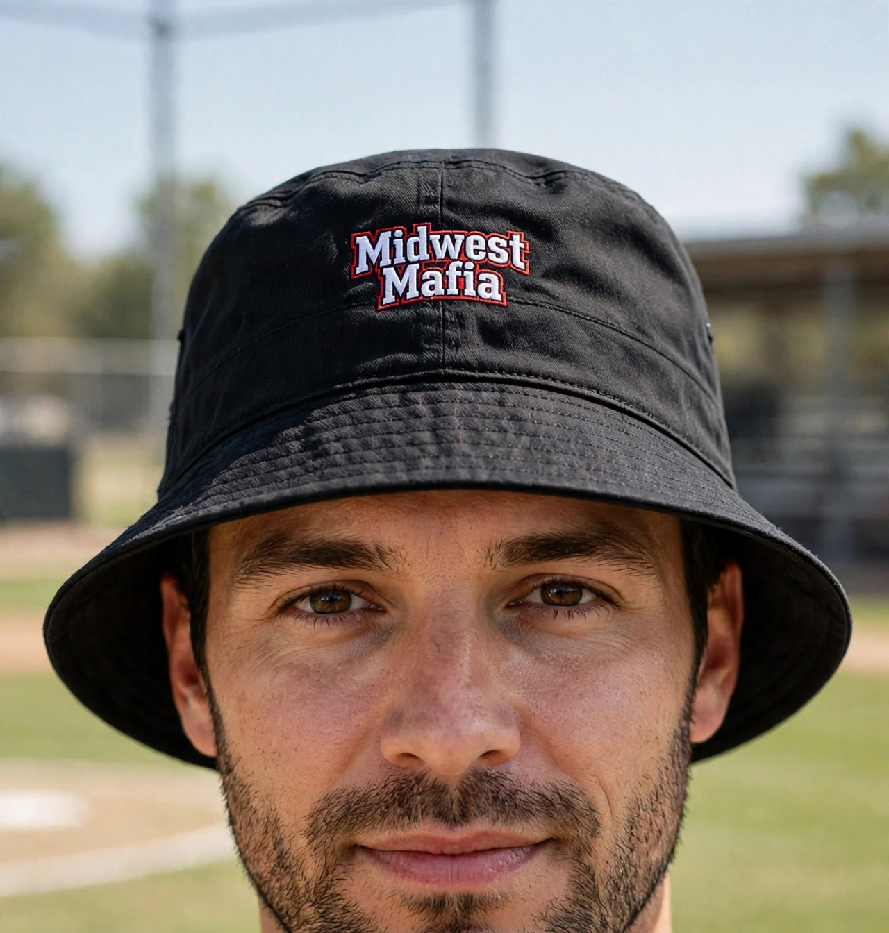 Adult softball fan wearing the black Midwest Mafia bucket hat at the ballfield